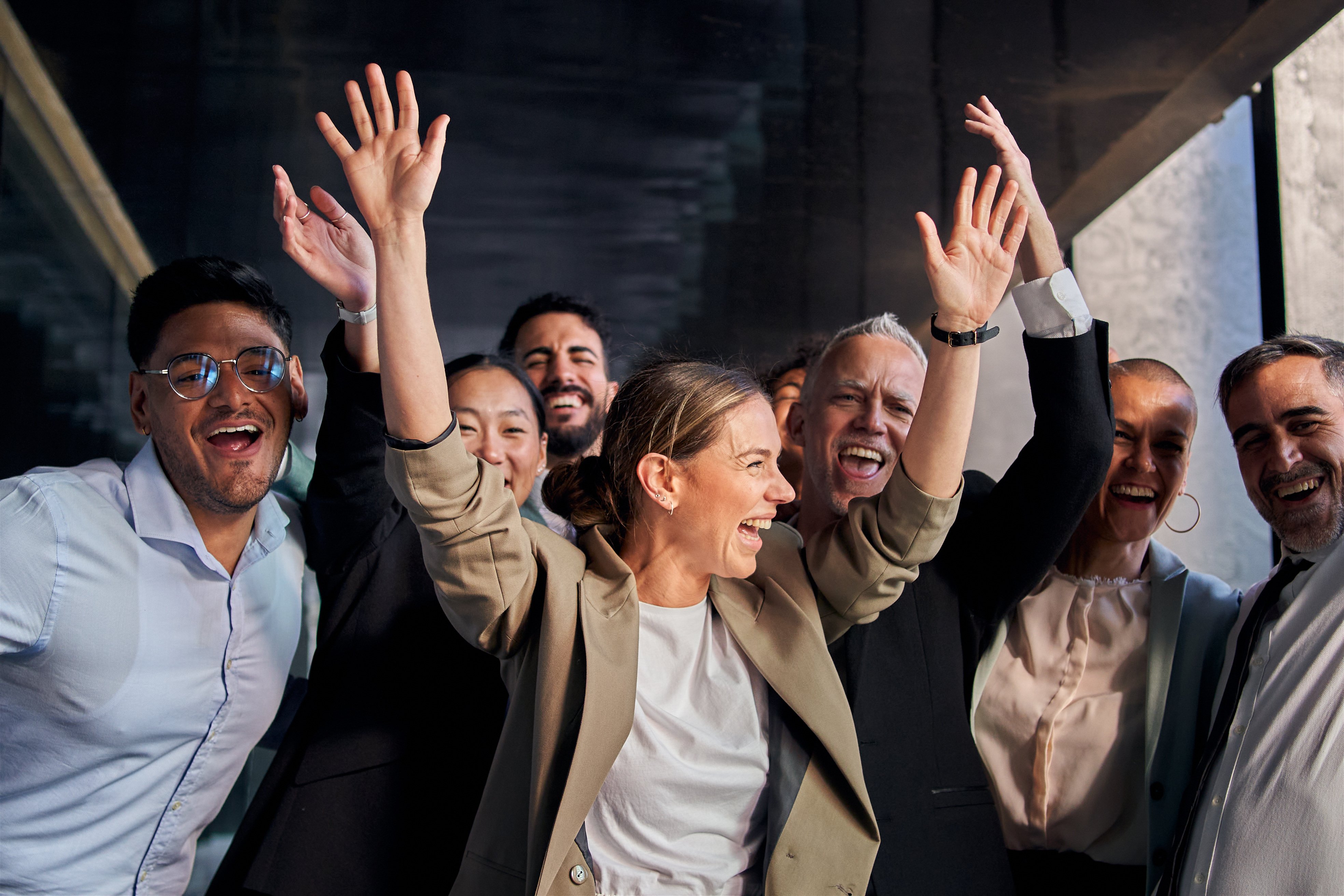 joyful-colleagues-celebrating-success-by-raising-t-2025-01-08-22-38-30-utc